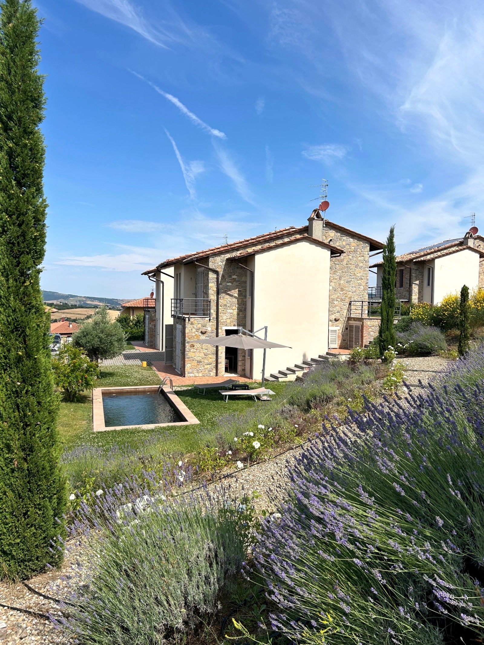 The garden and grounds seen from above, with lavender beds, the plunge pool and the neighbouring farmhouse